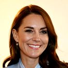 Kate Middleton nosila pepelkino različico poslovnega videza z bluzo s pentljo, dolgim plaščem in modrimi hlačami