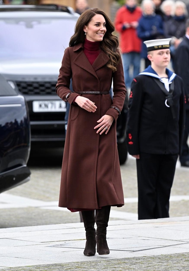 Kate je bila videti čudovito v dolgem rjavem plašču z ovratnikom s tankim temno rjavim pasom in manjšimi pasovi na …